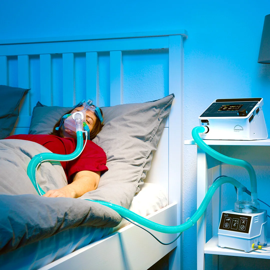 Пацієнт жінка лежить підключений апарат НІВЛ повнолицьова маска зволожувач Prisma AQUA